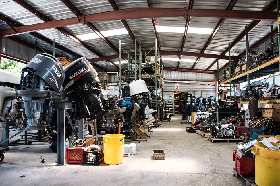 Photo of boat salvage yards with outboard motors and shelves of boating equipment