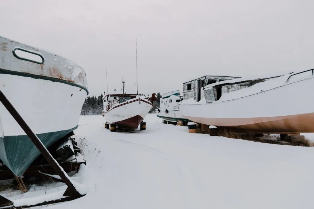 boats in a yard covered in snow