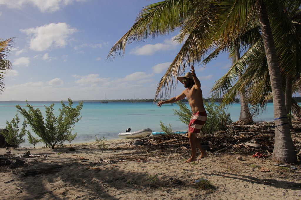 man slacklining on tropical beach