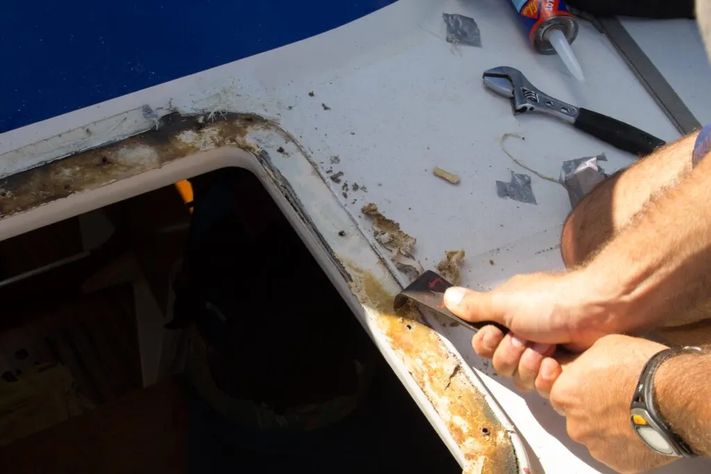 scraping sealant from hatch