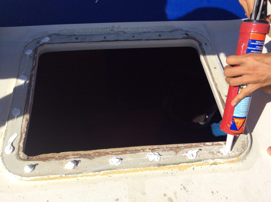 applying Sika Flex to leaky boat hatch