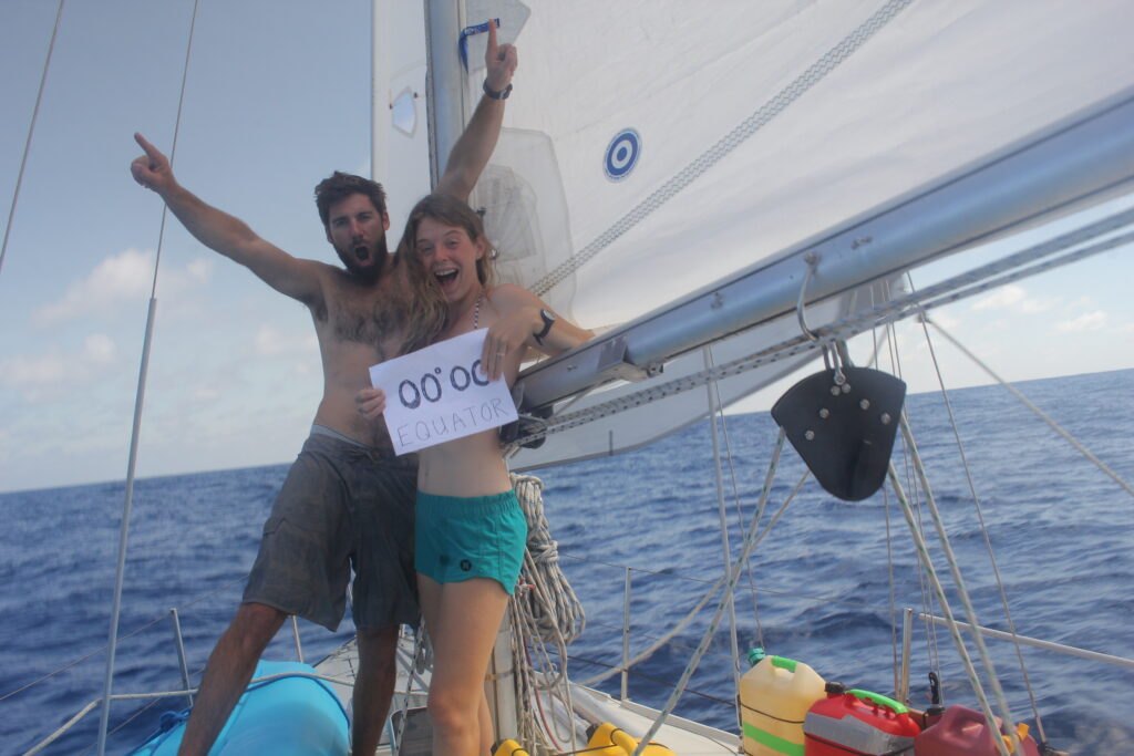 Man and woman on sailboat celebrating an equator crossing