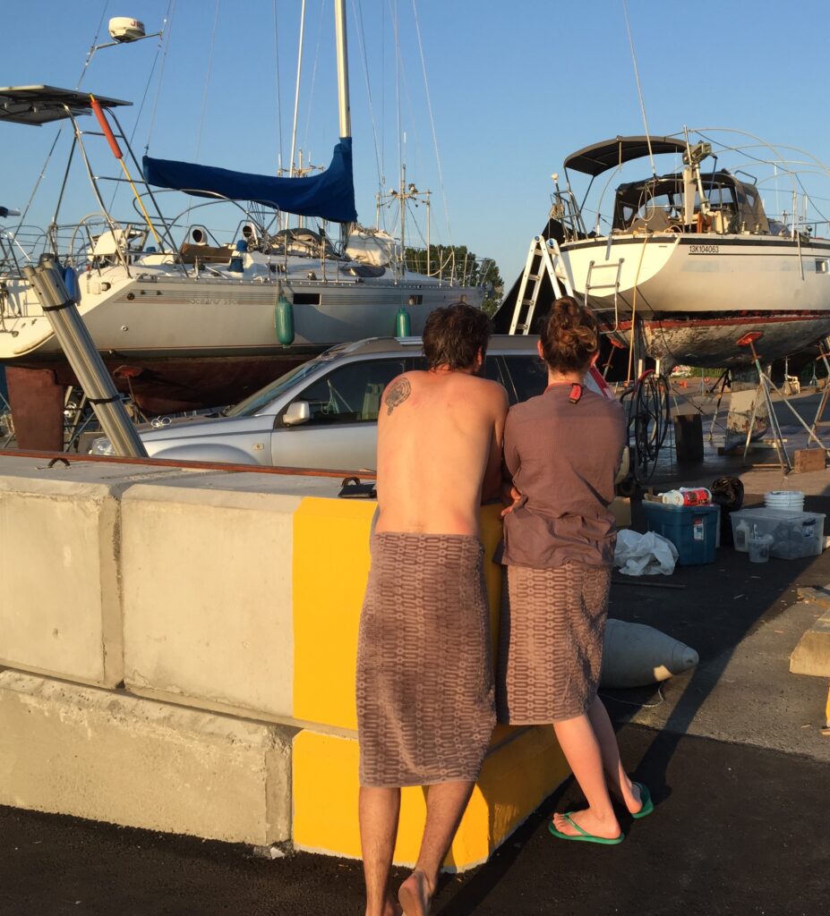 man and woman look out over boatyard