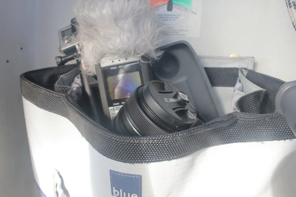 Canvas bag holding camera, recorder, and other electronic devices