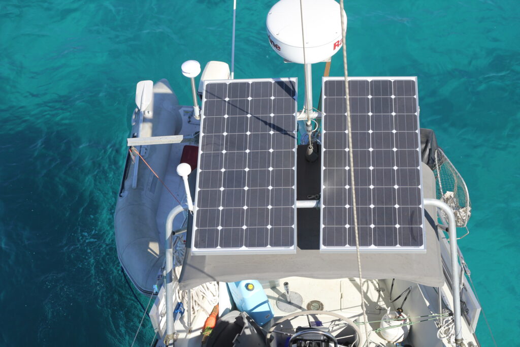 looking down on solar panels mounted on a sailboat arch